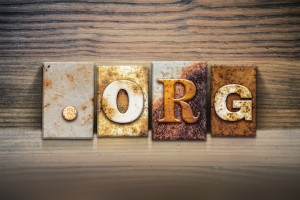 The word "DOT ORG" written in rusty metal letterpress type sitting on a wooden ledge background.